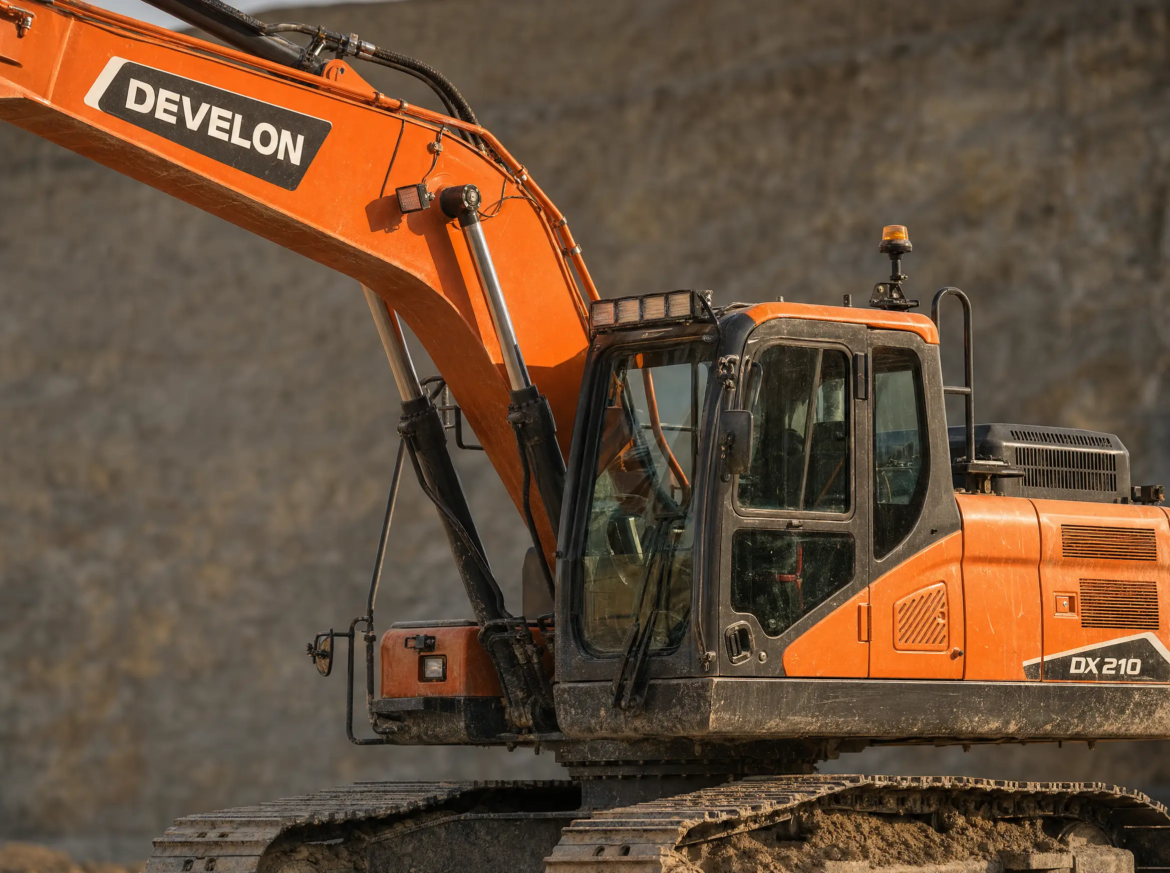A close detail of a DEVELON DX210 excavator